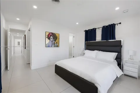 a bedroom with a bed and a painting