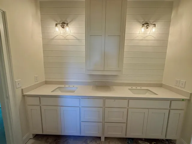 a bathroom with a sink and vanity