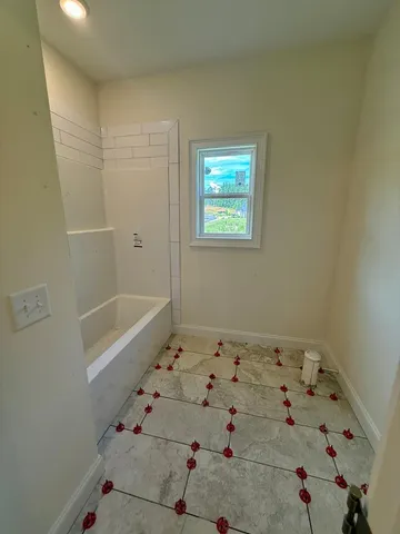 a bathroom with a bathtub and a shower