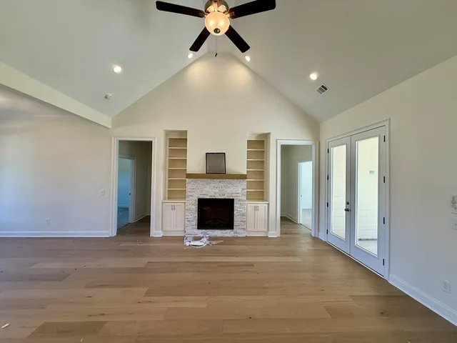 a view of a livingroom with a fireplace and window