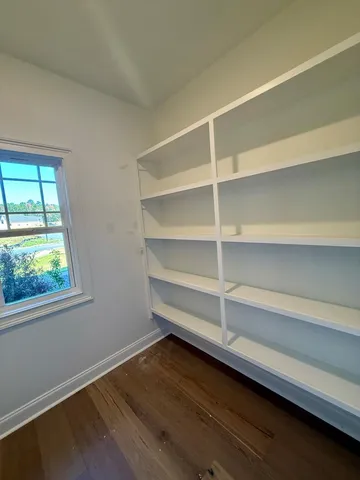a view of walk in closet with empty racks