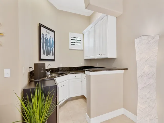 a kitchen with a sink a stove and cabinets