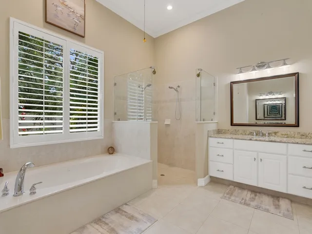 a bathroom with a tub sink and mirror