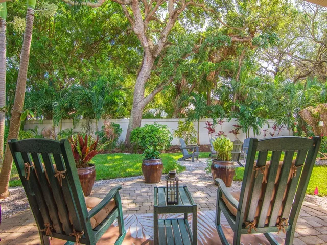a view of a chairs and table in patio