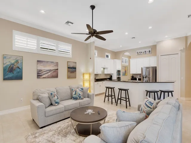 a living room with furniture a window and kitchen view