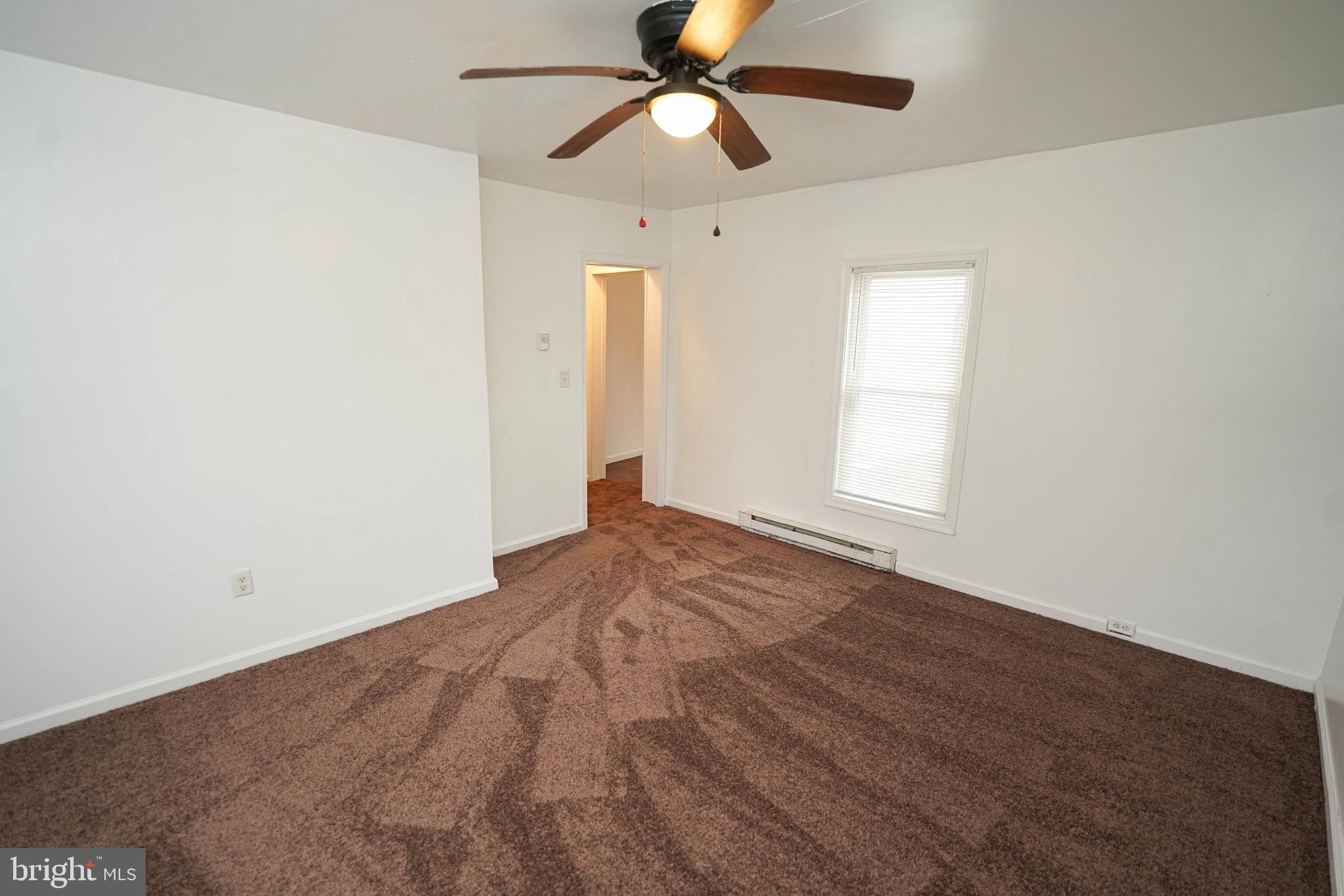 417 Walnut Street, Unit 2 Pocomoke City, MD 21851 - Photo 16 of 33 an empty room with closet and a chandelier fan
