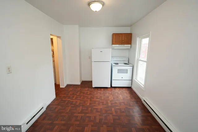 a view of a kitchen with a sink and a refrigerator