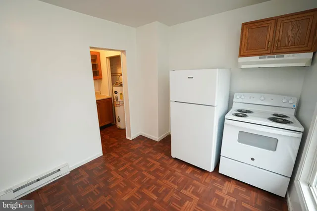a view of a storage and utility room with a refrigerator