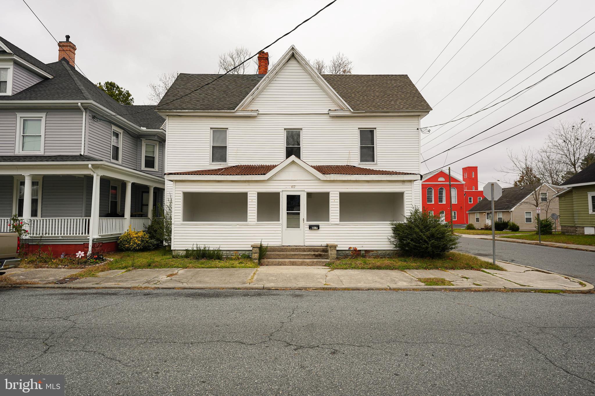 417 Walnut Street, Unit 2 Pocomoke City, MD 21851 - Photo 2 of 33 a front view of a house with a yard
