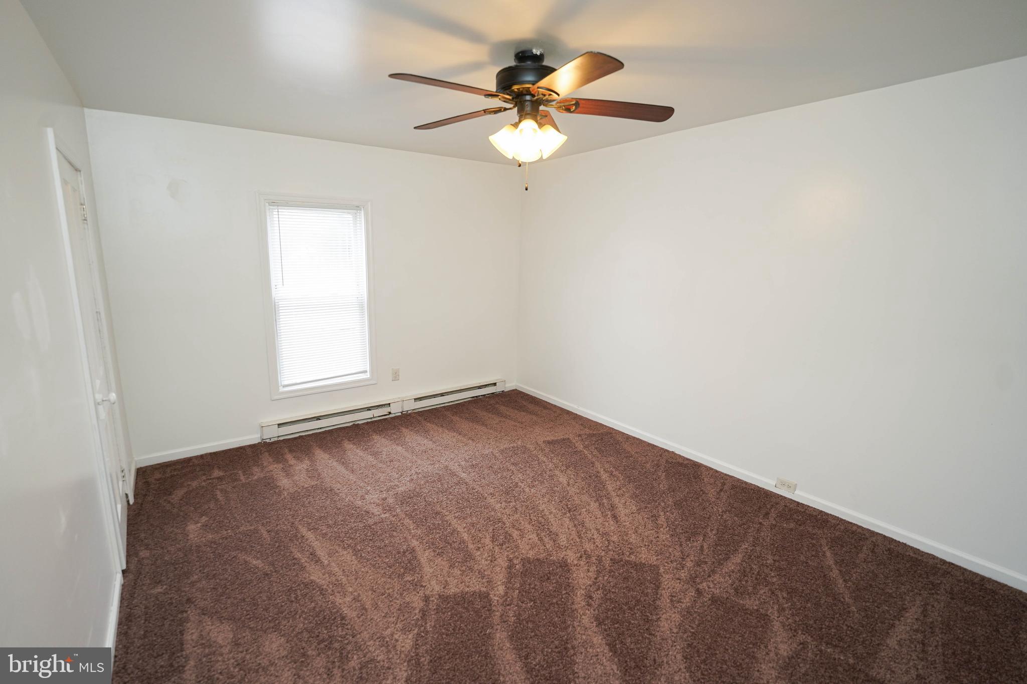 417 Walnut Street, Unit 2 Pocomoke City, MD 21851 - Photo 23 of 33 an empty room with a window and a fan