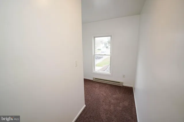 a view of an empty room and a window