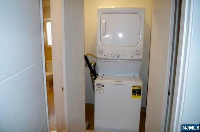 a hallway with wooden floor and staircase