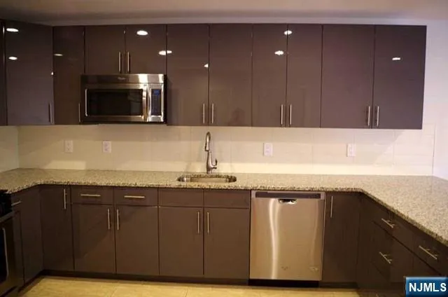 a kitchen with a sink and cabinets