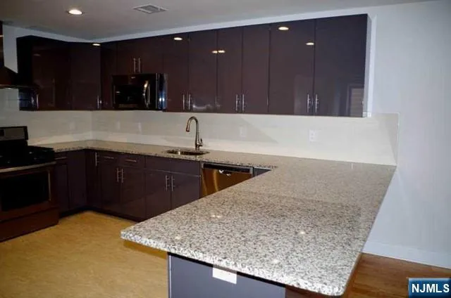 a kitchen with a sink and a wooden cabinets