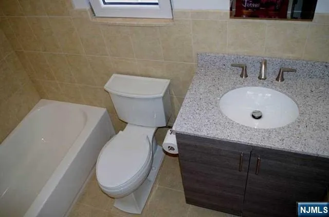 a bathroom with a bath tub with a shower