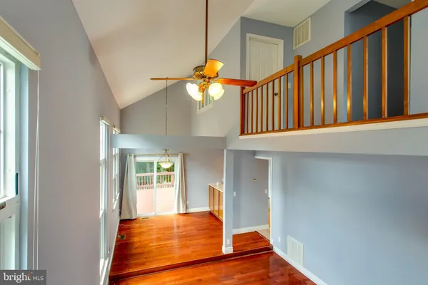 a bedroom with wooden floor and a window