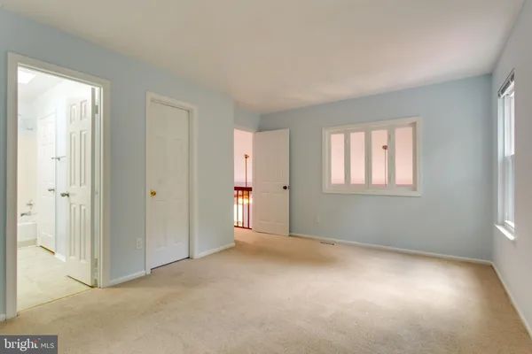 a view of an empty room with windows