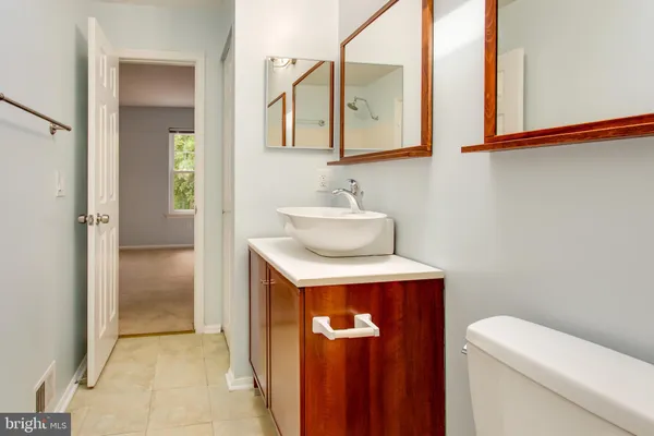 a bathroom with a sink a toilet and mirror