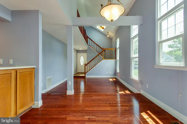 a view of entryway and hall with wooden floor