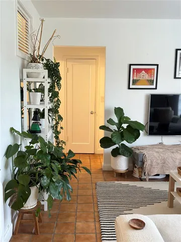a view of living room with furniture and a potted plant