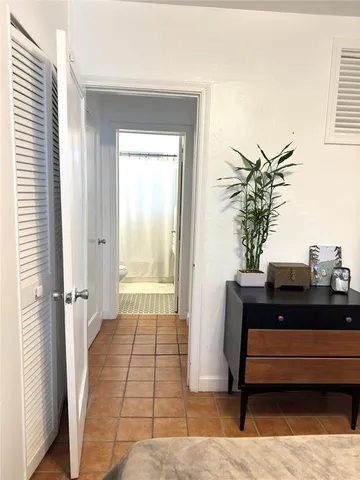 a room with a table and a potted plant