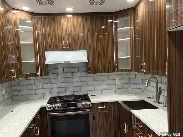 a kitchen that has a sink and a stove