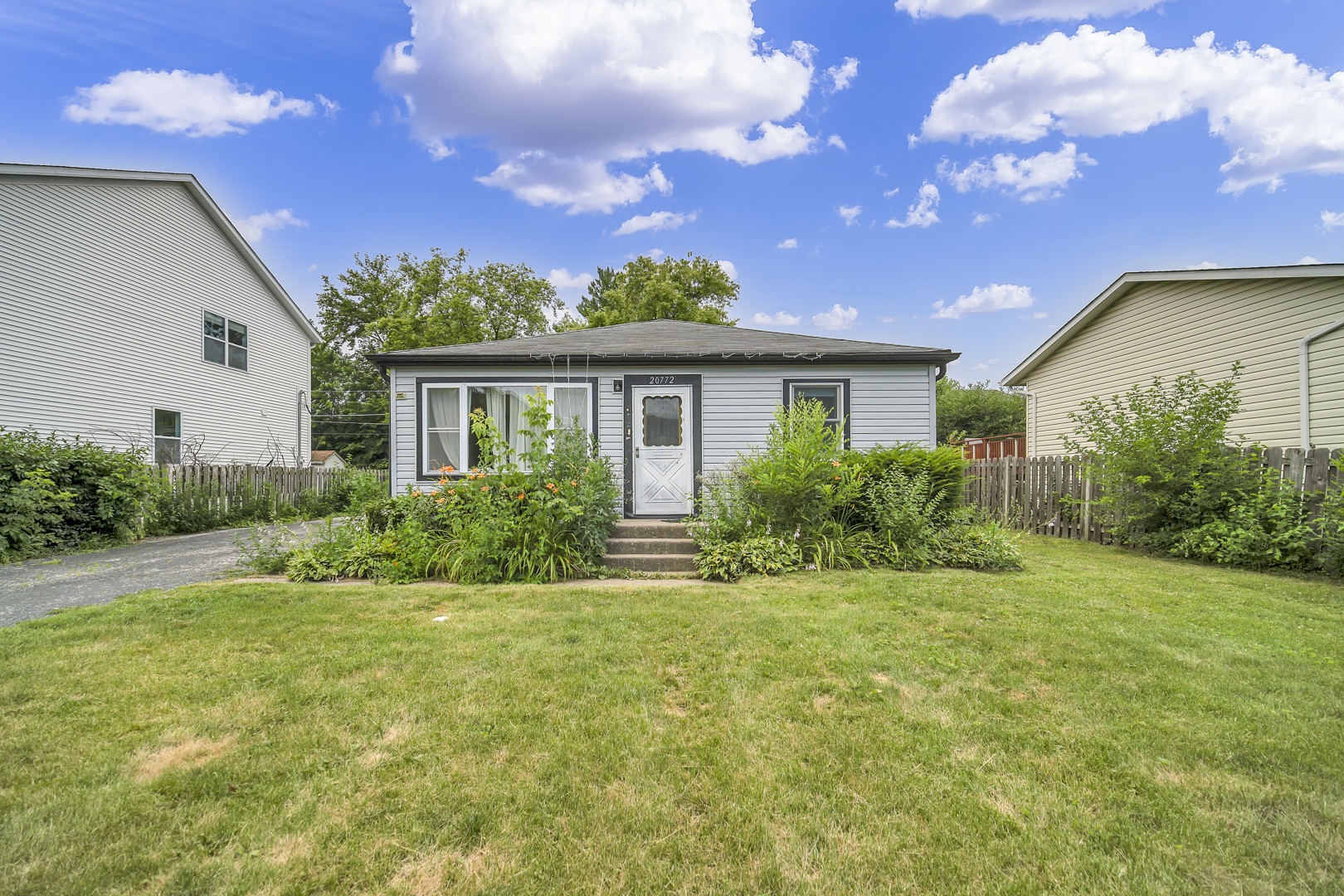 a front view of house with yard and green space