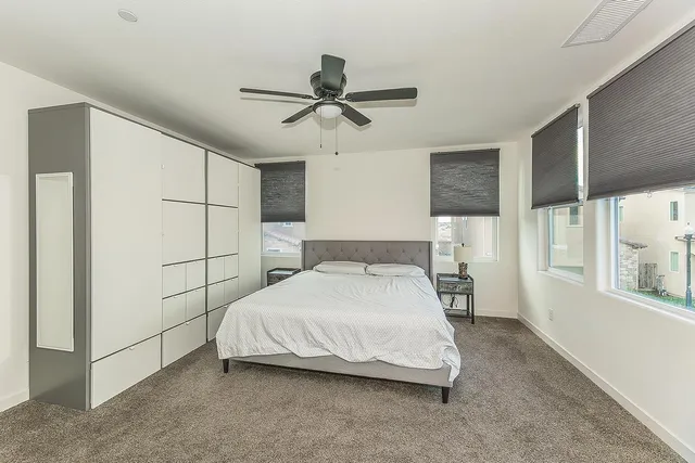 a bedroom with a bed and a window