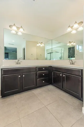 a spacious bathroom with a sink and a mirror