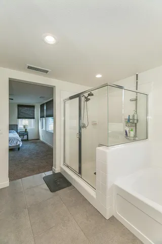 a bathroom with a shower and a tub