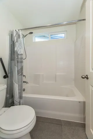 a bathroom with a shower and a toilet