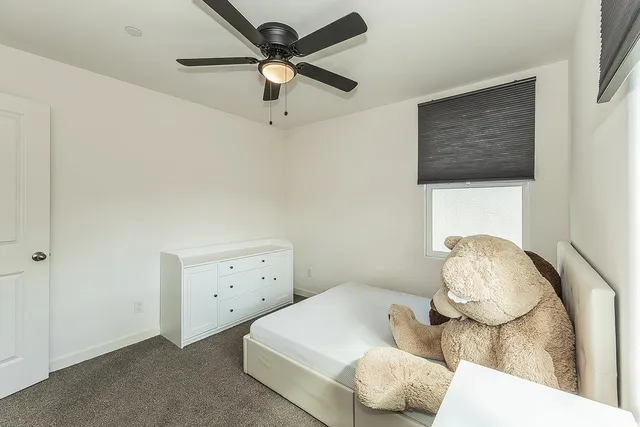 a bedroom with a bed and a painting on the wall