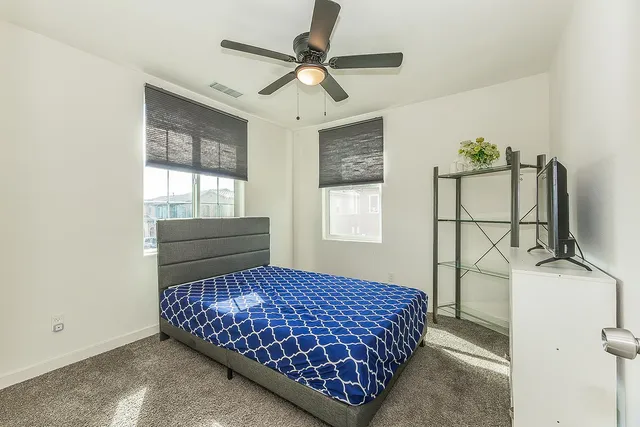 a bedroom with a bed and a flat screen tv