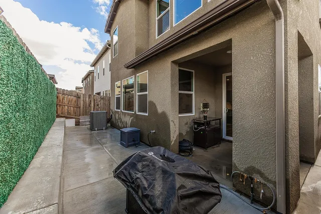 a view of a house with backyard and porch