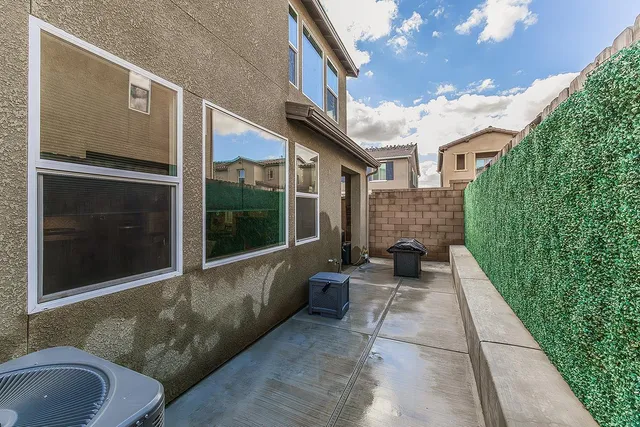 a view of a house with a large window and a yard