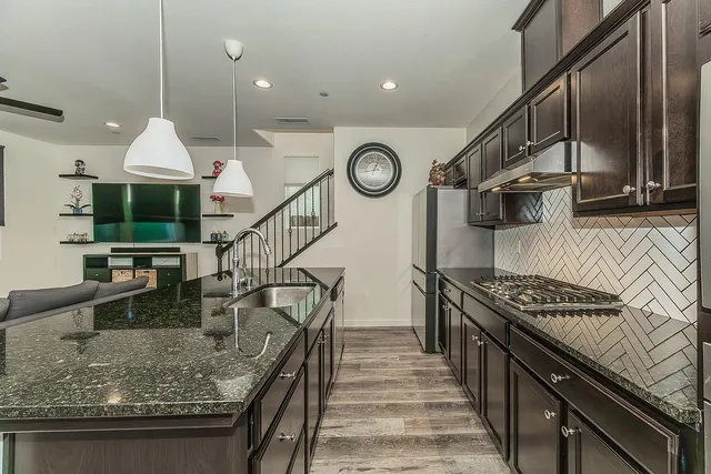 a kitchen with sink cabinets and stove