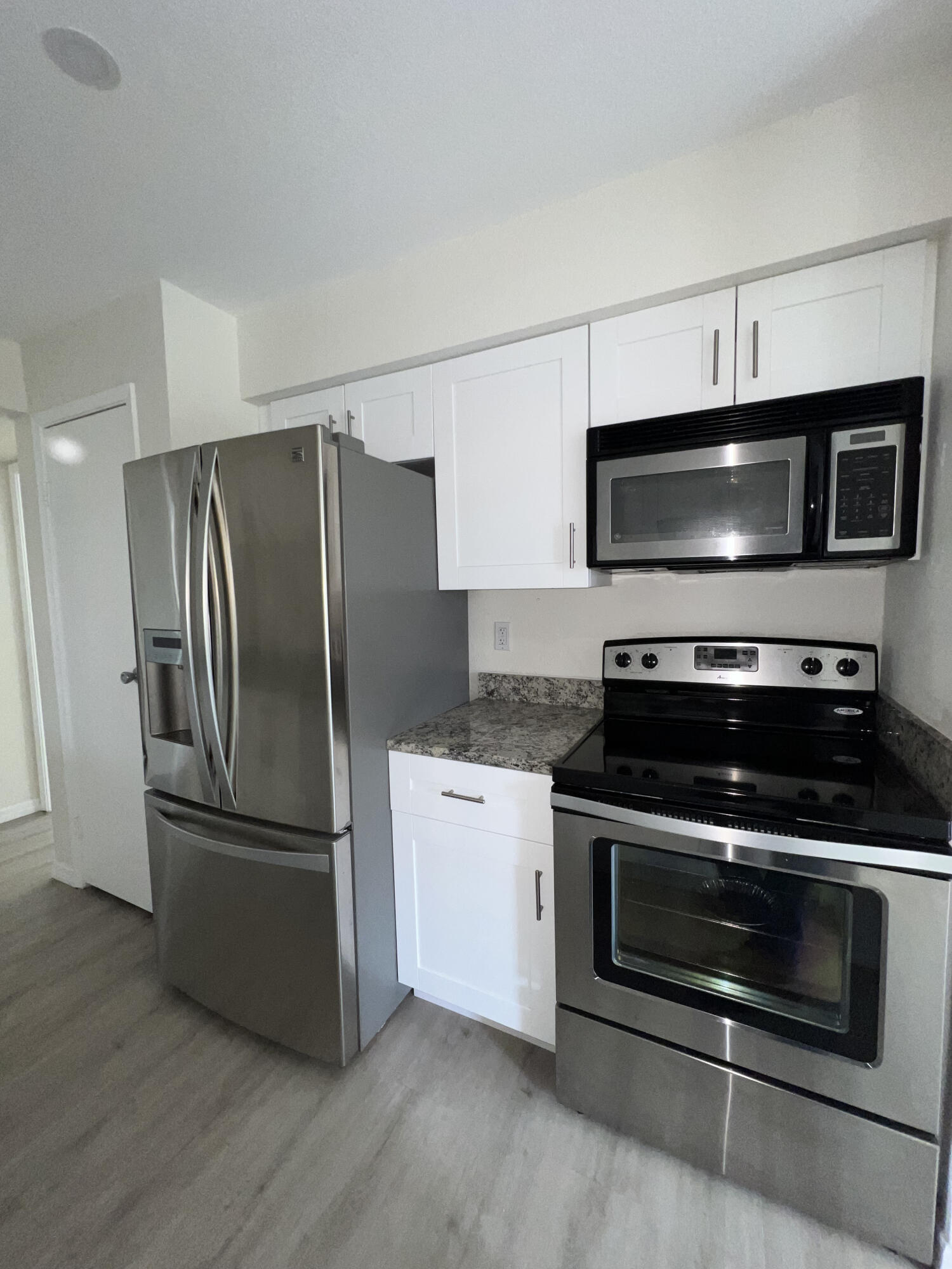 899 Riverside Drive, Unit 620 Coral Springs, FL 33071 - Photo 15 of 46 a kitchen with stainless steel appliances a stove a microwave and a refrigerator