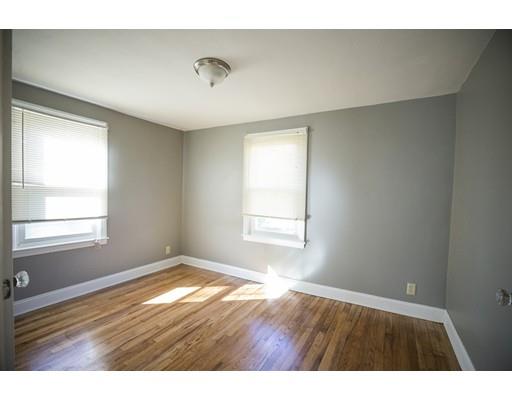 302 Island Pond Road Springfield, MA 01118 - Photo 13 of 25 a view of an empty room with wooden floor and a window