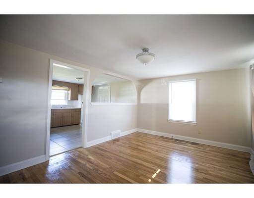 302 Island Pond Road Springfield, MA 01118 - Photo 4 of 25 a view of a livingroom with wooden floor and a window
