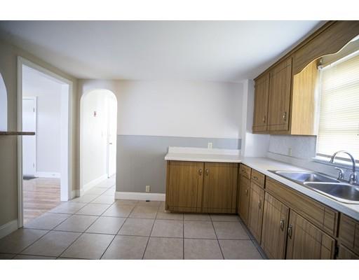 302 Island Pond Road Springfield, MA 01118 - Photo 7 of 25 a kitchen with a sink a refrigerator and cabinets