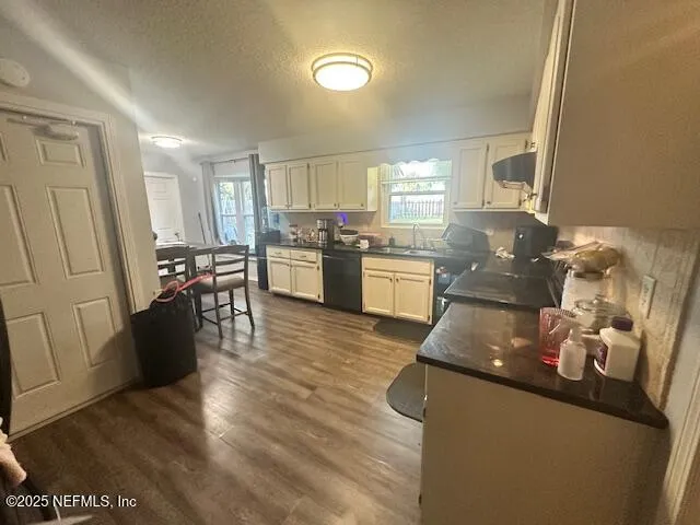 a kitchen with granite countertop a stove and a refrigerator