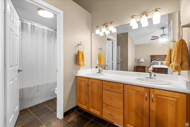 7824 South Sequoia Tree Lane Sandy, UT 84094 - Photo 21 of 43 Full bath featuring connected bathroom, double vanity, ceiling fan, and shower / tub combo with curtain