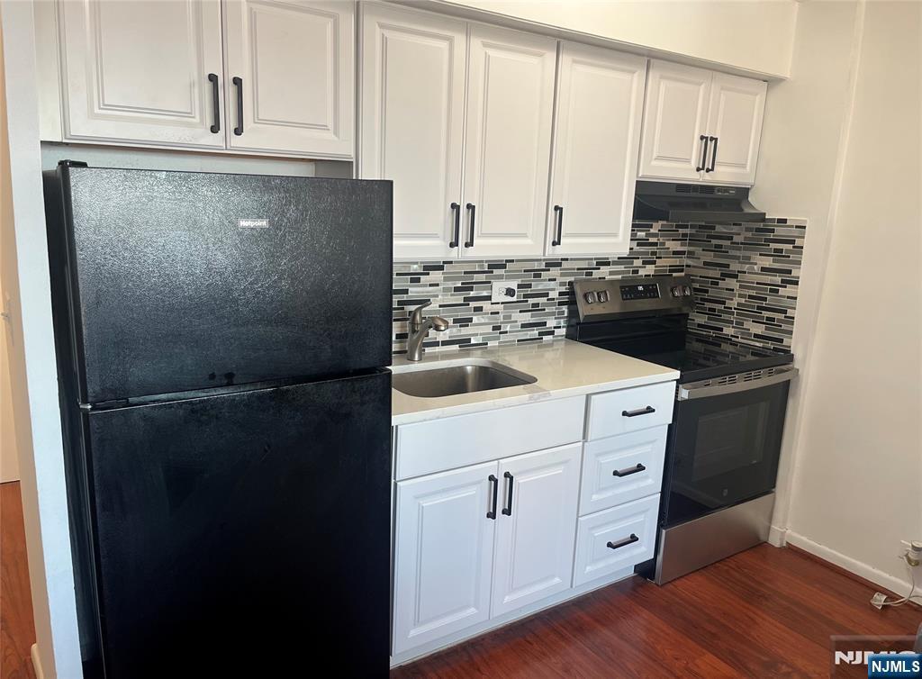 265 Main Street, Unit 506 Ridgefield Park, NJ 07660 - Photo 1 of 8 a kitchen with a refrigerator stove and cabinets