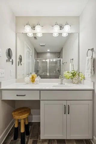 a bathroom with a sink vanity and a mirror