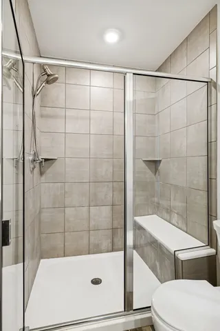 a bathroom with a shower and a toilet