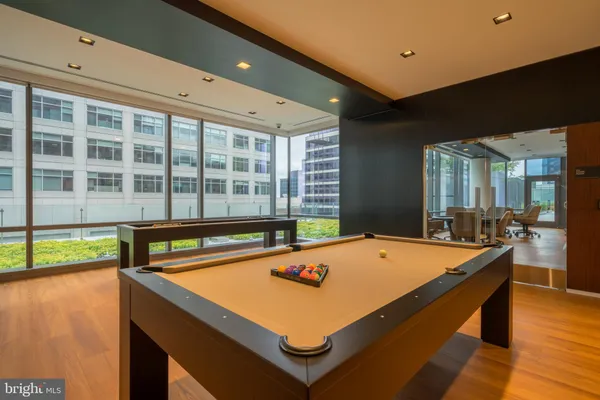 a room with pool table and windows