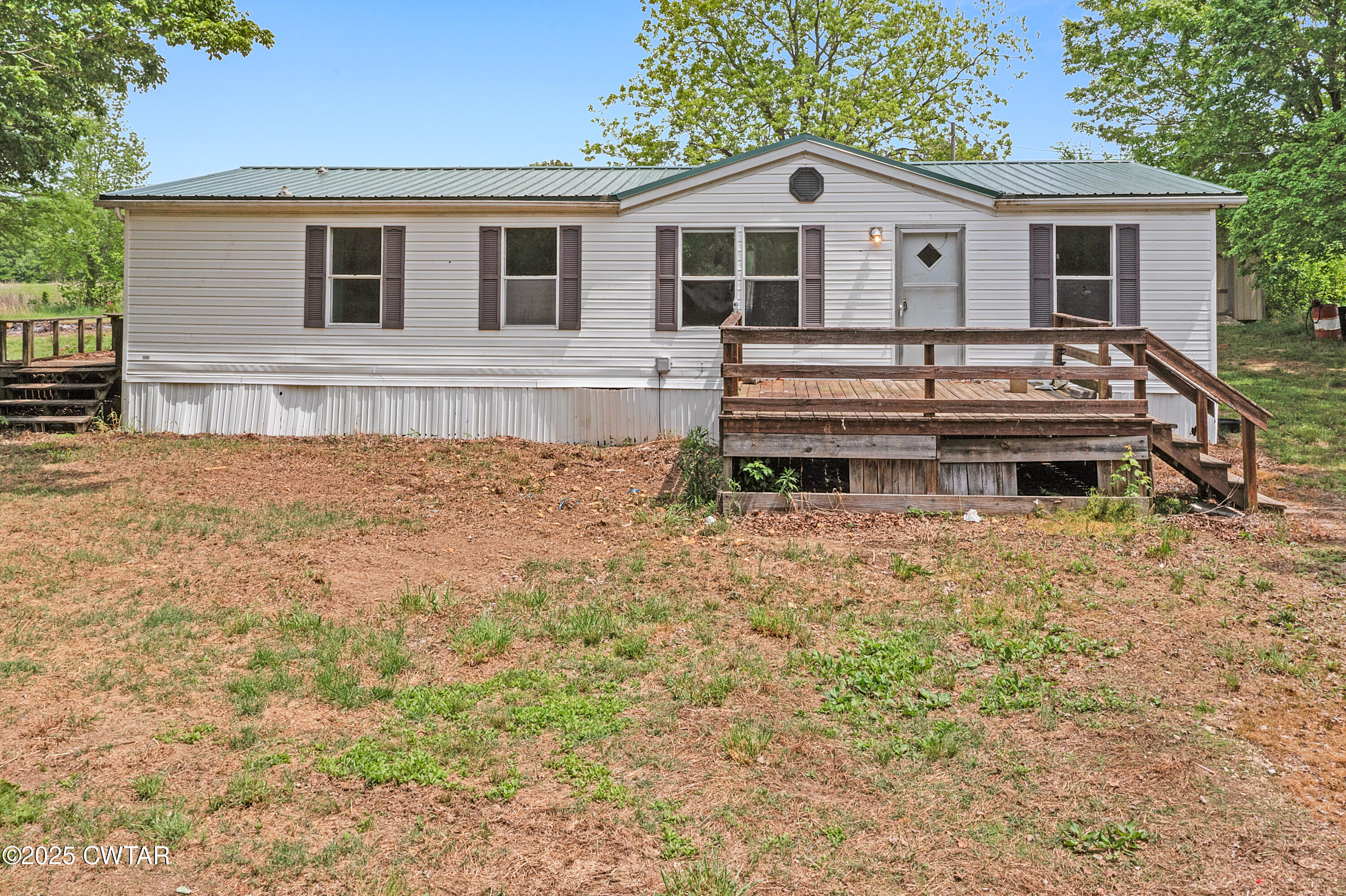 713 Caudle Store Road Greenfield, TN 38230 - Photo 1 of 28 a house view with a garden space