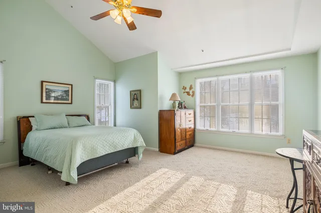 a spacious bedroom with a bed and a large window