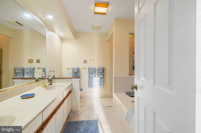 a en suite bathroom with a sink a large mirror and shower