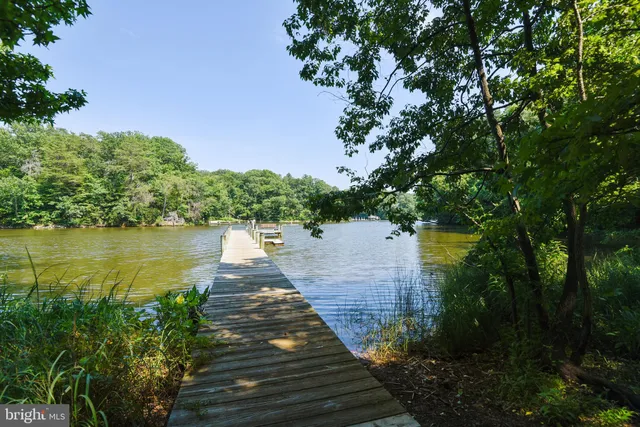 a backyard of a house with lots of green space and fountain